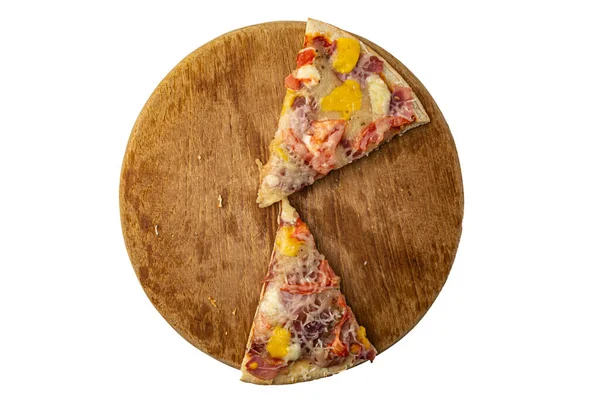 Two slices of pizza on a round wooden board on a white background top view — Fotografia de Stock