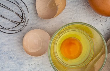 Raw eggs in package and whisk on kitchen table. High quality photo