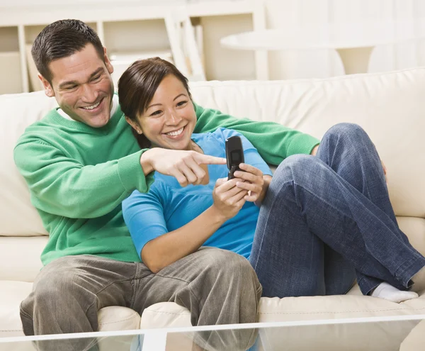 Mixed race couple watching TV together — Stock Photo, Image