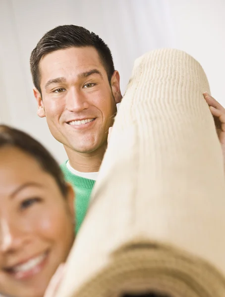 Attractive Couple with Roll of Carpet — Stock Photo, Image