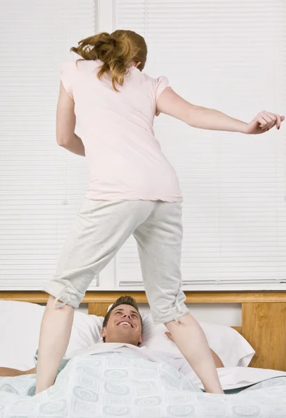 Mujer bailando en la cama —  Fotos de Stock