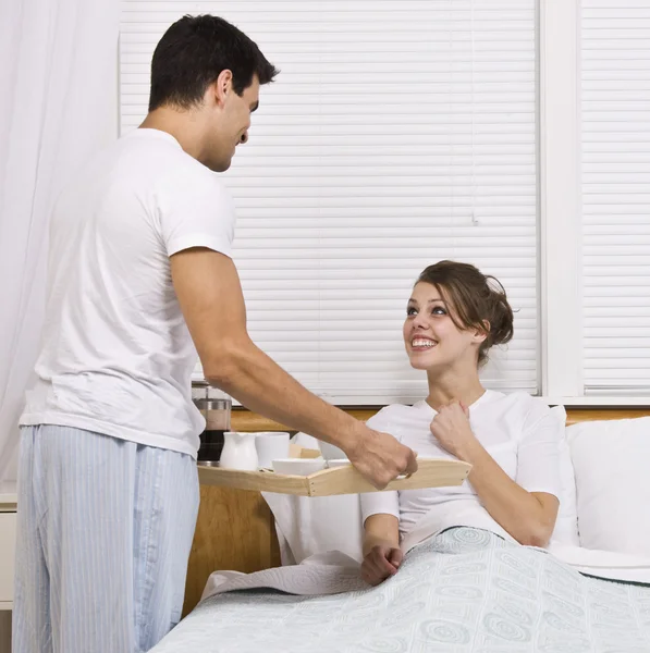 Male serving female breakfast in bed — Stock Photo, Image