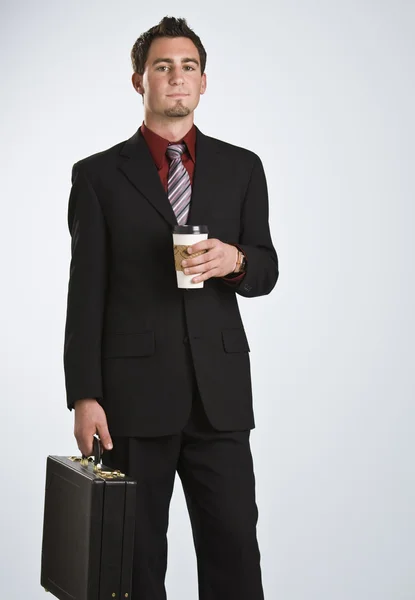 Attractive man with coffee and briefcase — Stock Photo, Image