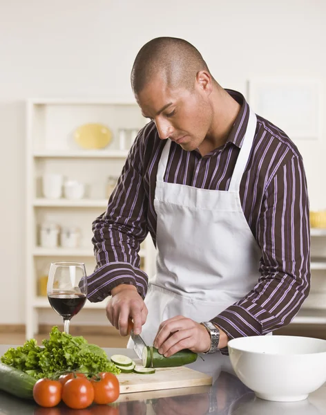 Attractive male cutting salad — Stock Photo, Image
