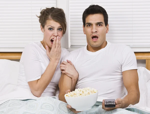 Surprised Young Couple Watching TV — Stock Photo, Image