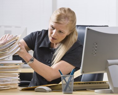 Woman Looking Through Paperwork clipart