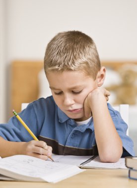 Boy Working on Homework clipart