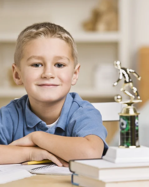 Boy Sitting in Front of Soccer Trophy — Stock Photo, Image