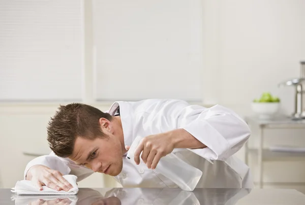 Attractive male cleaning table. — Stock Photo, Image