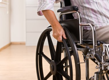 Senior woman sitting in wheelchair clipart