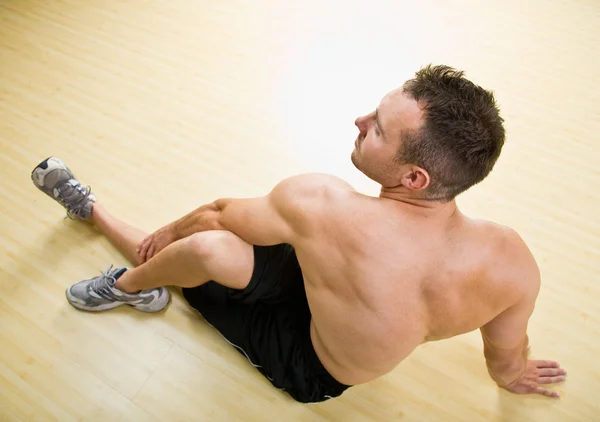 Man stretching in health club — Stock Photo, Image