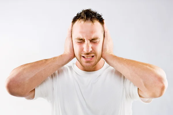 Man blocking out loud noise from ears — Stock Photo, Image