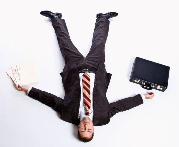 Businessman laying on floor and briefcase — Stock Photo, Image