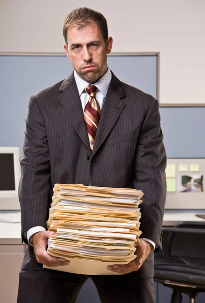 Businessman carrying stack of file folders — Stock Photo, Image