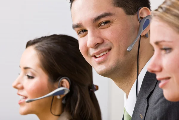 Business talking on headsets — Stock Photo, Image