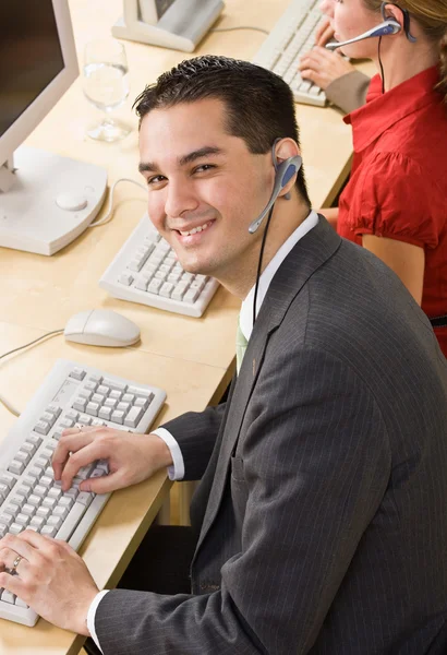 Businessman talking on headsets — Stock Photo, Image