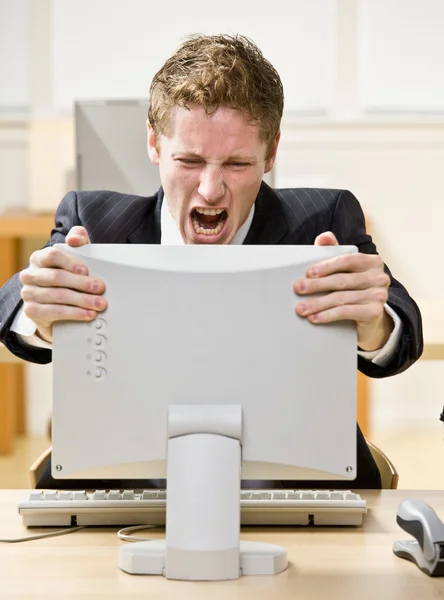 Businessman shouting at computer — Stock Photo, Image