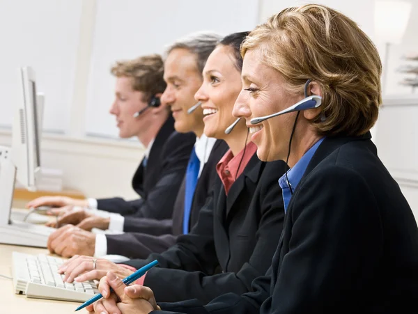 Business talking on headsets — Stock Photo, Image