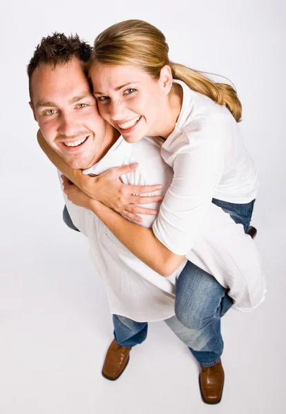 Boyfriend giving girlfriend piggy back ride Royalty Free Stock Images