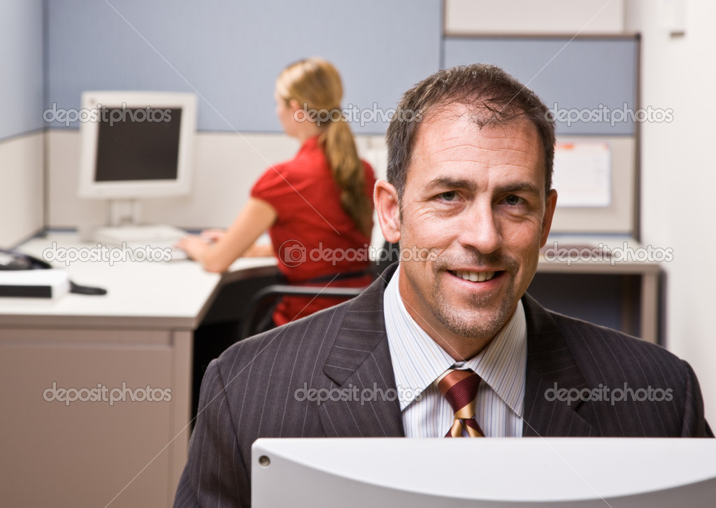 Businessman sitting at desk smiling