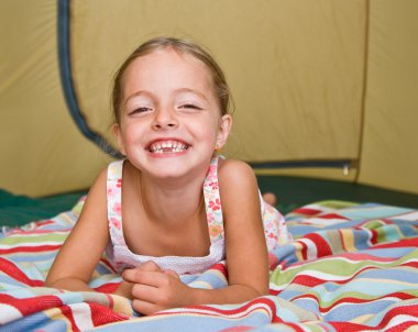 Girl laying in tent clipart