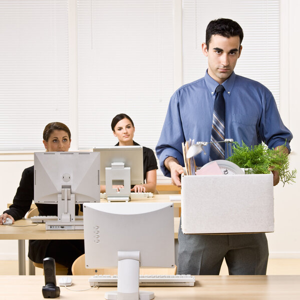 Fired businessman carrying box