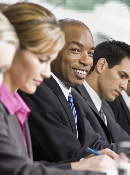 Empresario en la reunión sonriendo — Foto de Stock