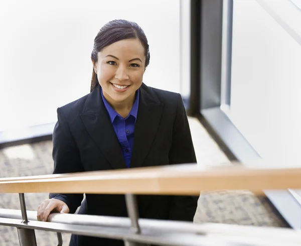 Junge Geschäftsfrau auf der Treppe lächelt — Stockfoto