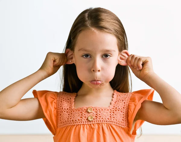 Young girl pulling ears — Stock Photo, Image