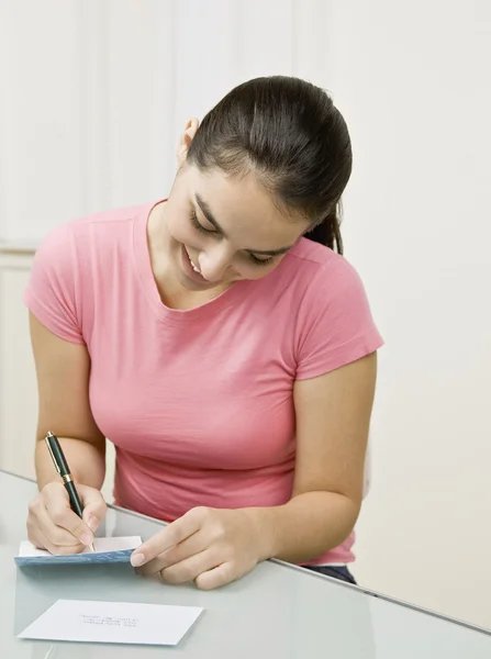 Young Woman Writing on Card — Stock Photo, Image