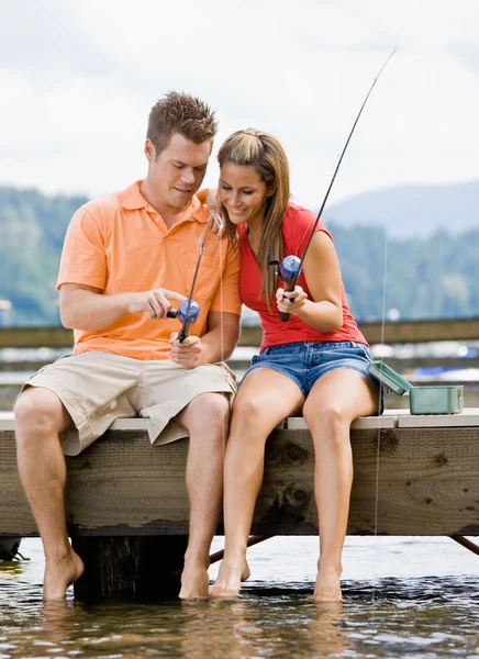Couple fishing on pier — Stock Photo, Image