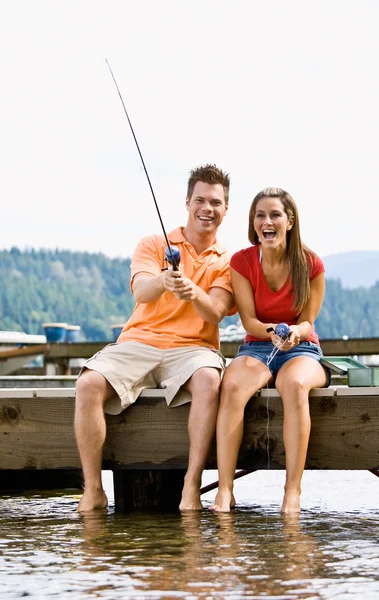 Couple fishing on pier — Stock Photo, Image