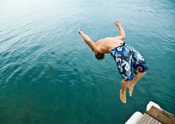 Uomo che fa back-flip nel lago — Foto Stock