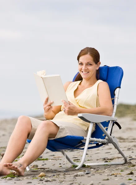 Vrouw lezing boek bij strand — Stockfoto