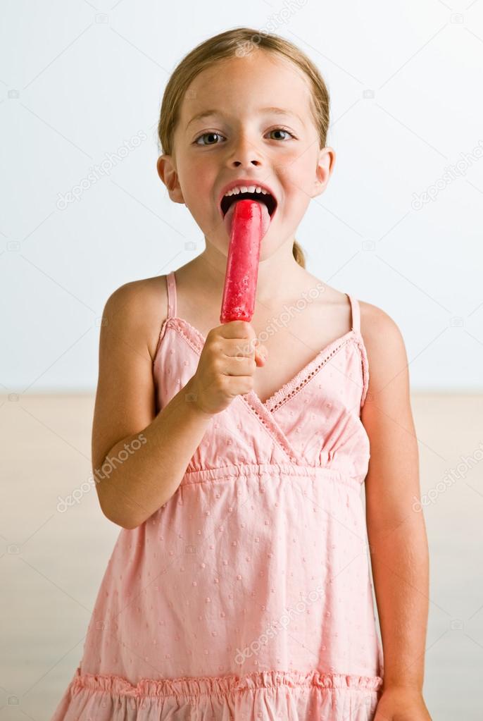 Girl licking popsicle