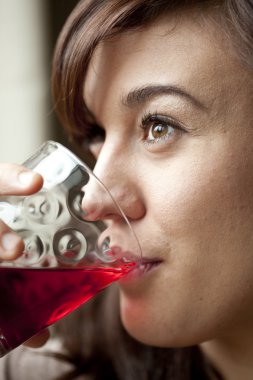 Young Woman Drinking Cranberry Juice clipart