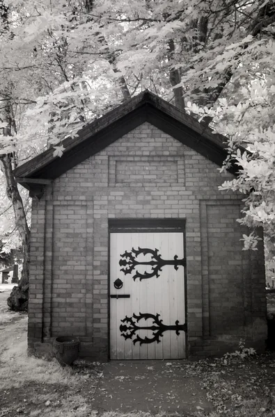 Infrared Photo of a Small Brick Building at a Cemetery — Stock Photo, Image