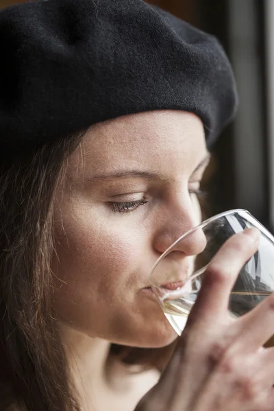 Młoda kobieta pije wino białe — Zdjęcie stockowe