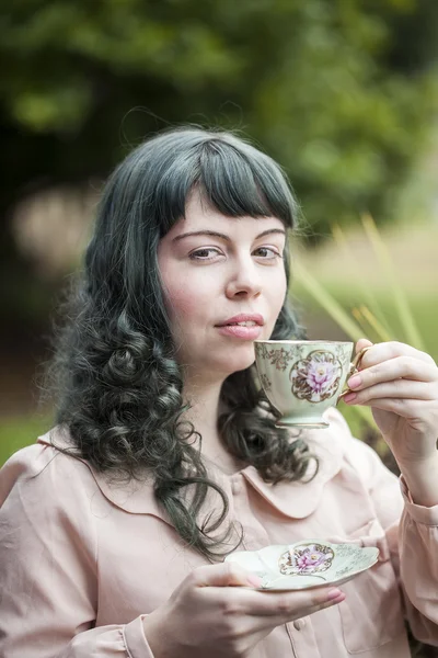 Mujer joven con taza de té antiguo — Foto de Stock