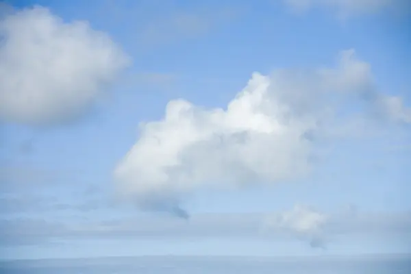 Three cloulds against blue sky. — Stock Photo, Image