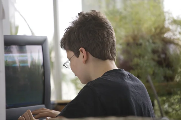 Niño de la escuela secundaria usando una computadora —  Fotos de Stock