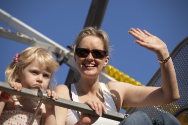 Mother and Daughter on a Ride at the Fair clipart