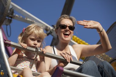 Mother and Daughter on a Ride at the Fair clipart