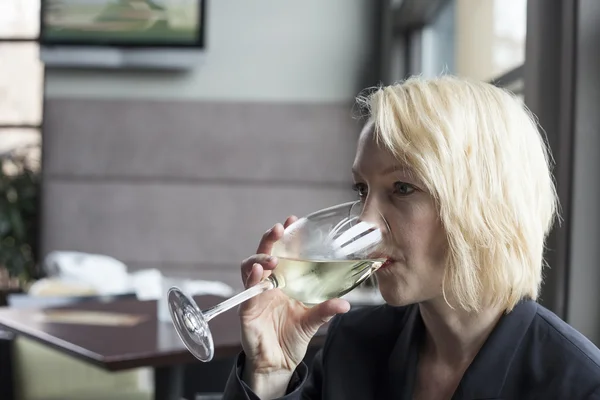 Blonde Woman with Beautiful Blue Eyes Drinking Glass of White Wi — Stock Photo, Image