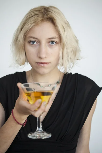 Blonde Young Woman with Beautiful Blue Eyes Drinks a Martini — Stock Photo, Image