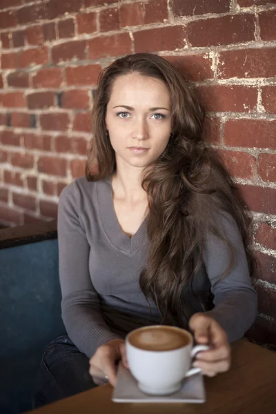 Jeune femme aux beaux yeux verts avec tasse de café blanche — Photo