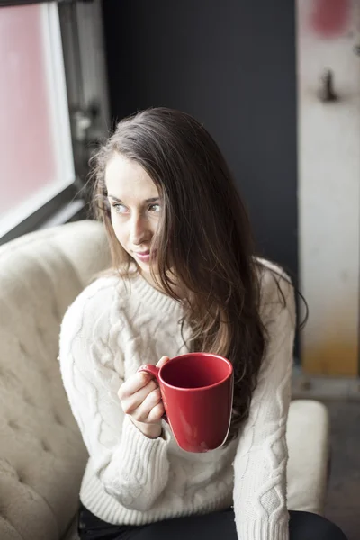 Vacker ung kvinna med brunt hår och ögon som dricker kaffe — Stockfoto