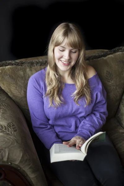 Jeune femme aux beaux yeux bleus lisant un livre — Photo