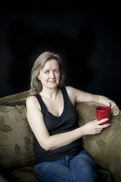 Blonde Woman with Red Coffee Cup on Black Background — Stock Photo, Image