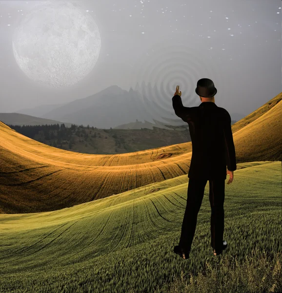 Man touches sky in landscape creting ripples in the scene — Stock Photo, Image